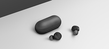 אוזניות כפתור אלחוטיות לחלוטין מדגם WF-C500 ונרתיק טעינה (בשחור) על רקע בצבע אפור בהיר