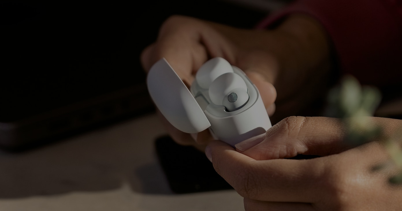 Image of a pair of hands holding Sony Truly Wireless earbuds in a carrying case